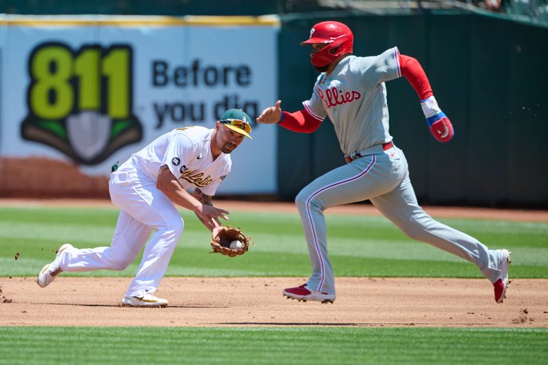 Jun 17, 2023; Oakland, California, USA; Oakland Athletics infielder Jace Peterson (6) fields a ground ball and Philadelphia Phillies infielder Edmundo Sosa (33) runs to second base during the third inning at Oakland-Alameda County Coliseum. Mandatory Credit: Robert Edwards-USA TODAY Sports