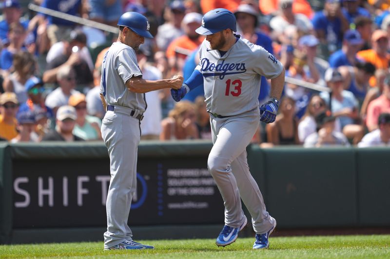 Jul 19, 2023; Baltimore, Maryland, USA; Los Angeles Dodgers third baseman Max Muncy (13) greeted by coach Dino Ebel (91) following his two run home run in the fifth inning against the Baltimore Orioles at Oriole Park at Camden Yards. Mandatory Credit: Mitch Stringer-USA TODAY Sports