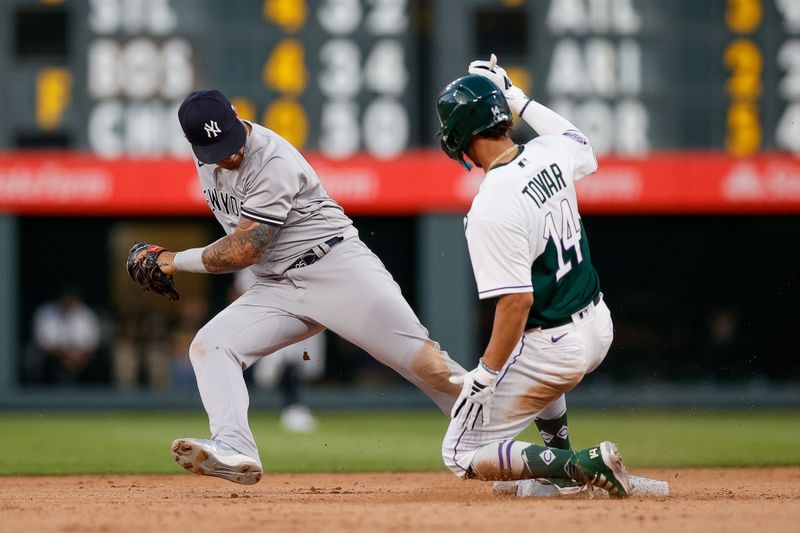 Jul 15, 2023; Denver, Colorado, USA; Colorado Rockies shortstop Ezequiel Tovar (14) safely tags up at second against New York Yankees second baseman Gleyber Torres (25) in the seventh inning at Coors Field. Mandatory Credit: Isaiah J. Downing-USA TODAY Sports