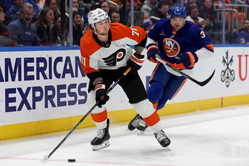 Jan 24, 2025; Elmont, New York, USA; Philadelphia Flyers right wing Tyson Foerster (71) looks to pass the puck against New York Islanders defenseman Adam Pelech (3) during the first period at UBS Arena. Mandatory Credit: Brad Penner-Imagn Images