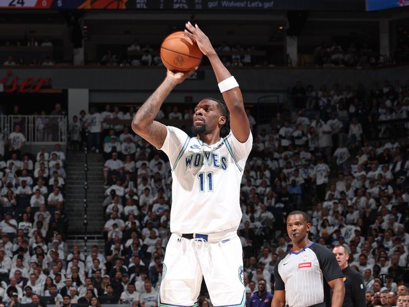 MINNEAPOLIS, MN -  APRIL 23: Naz Reid #11 of the Minnesota Timberwolves shoots a three point basket during the game against the Phoenix Suns during Round 1 Game 2 of the 2024 NBA Playoffs on April 23, 2024 at Target Center in Minneapolis, Minnesota. NOTE TO USER: User expressly acknowledges and agrees that, by downloading and or using this Photograph, user is consenting to the terms and conditions of the Getty Images License Agreement. Mandatory Copyright Notice: Copyright 2024 NBAE (Photo by David Sherman/NBAE via Getty Images)