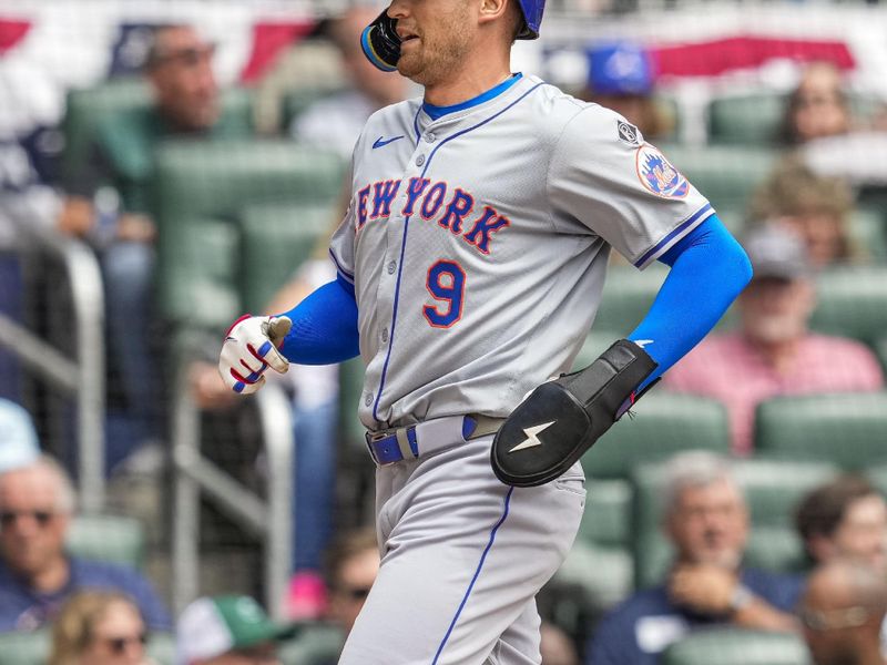 Apr 11, 2024; Cumberland, Georgia, USA; New York Mets left fielder Brandon Nimmo (9) scores a run against the Atlanta Braves during the second inning at Truist Park. Mandatory Credit: Dale Zanine-USA TODAY Sports