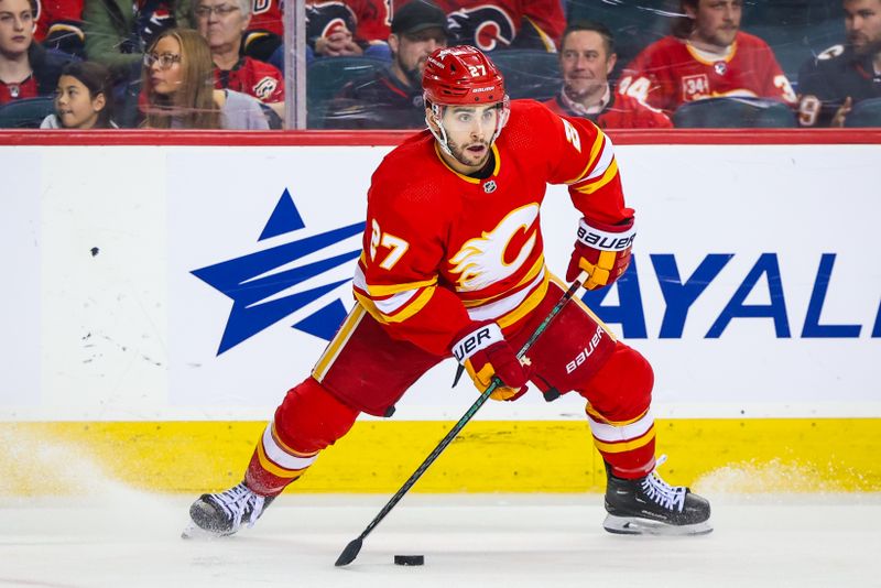 Apr 18, 2024; Calgary, Alberta, CAN; Calgary Flames right wing Matt Coronato (27) controls the puck against the San Jose Sharks during the third period at Scotiabank Saddledome. Mandatory Credit: Sergei Belski-USA TODAY Sports