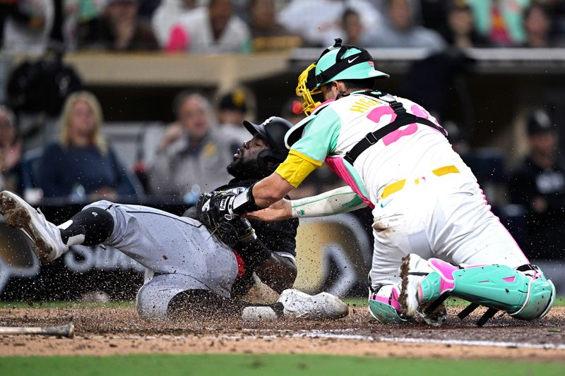 Sep 20, 2024; San Diego, California, USA; Chicago White Sox third baseman Bryan Ramos (44) is tagged out at home by San Diego Padres catcher Kyle Higashioka (20) during the tenth inning at Petco Park. Mandatory Credit: Orlando Ramirez-Imagn Images