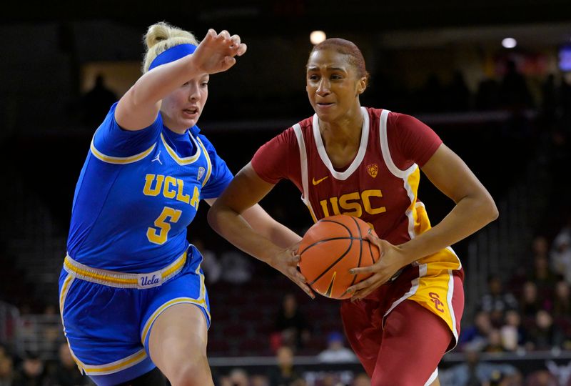 Dec 15, 2022; Los Angeles, California, USA;  USC Trojans forward Kadi Sissoko (30) is defended by UCLA Bruins forward Brynn Masikewich (5) in the first half at Galen Center. Mandatory Credit: Jayne Kamin-Oncea-USA TODAY Sports