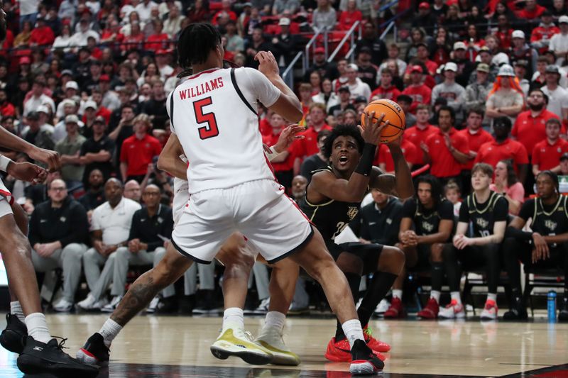 Feb 10, 2024; Lubbock, Texas, USA;  Central Florida Knights guard Jaylin Sellers (24) looks to shoot against Texas Tech Red Raiders guard Darrion Williams (5) in the second half at United Supermarkets Arena. Mandatory Credit: Michael C. Johnson-USA TODAY Sports