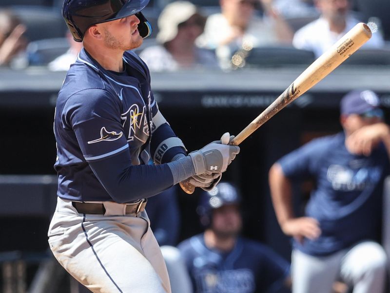 May 3, 2025; Bronx, New York, USA;  Tampa Bay Rays first baseman Curtis Mead (25) hits an RBI single in the eighth inning against the New York Yankees at Yankee Stadium. Mandatory Credit: Wendell Cruz-Imagn Images