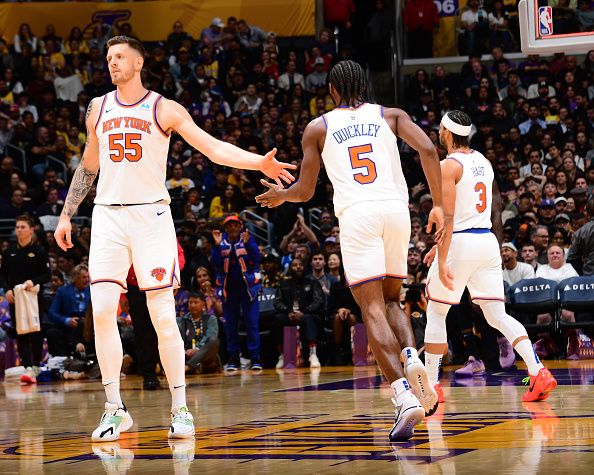 LOS ANGELES, CA - DECEMBER 18:  Isaiah Hartenstein #55 of the New York Knicks & Immanuel Quickley #5 of the New York Knicks high five during the game  on December 18, 2023 at Crypto.Com Arena in Los Angeles, California. NOTE TO USER: User expressly acknowledges and agrees that, by downloading and/or using this Photograph, user is consenting to the terms and conditions of the Getty Images License Agreement. Mandatory Copyright Notice: Copyright 2023 NBAE (Photo by Adam Pantozzi/NBAE via Getty Images)