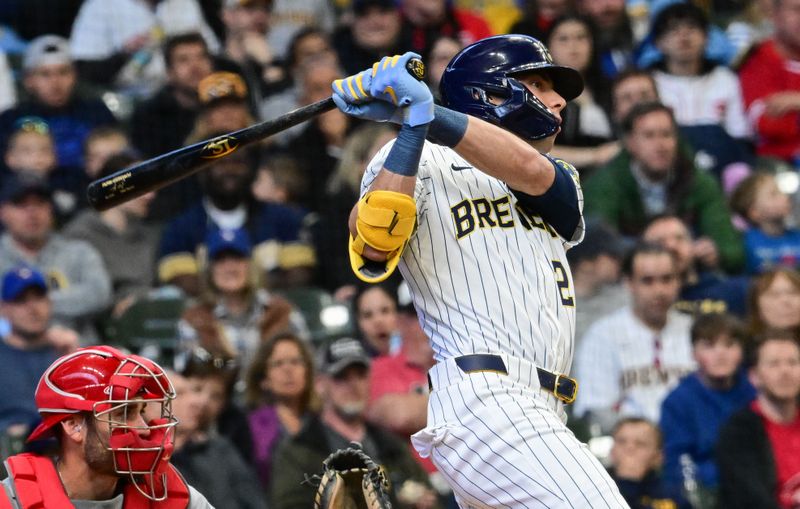 Apr 6, 2025; Milwaukee, Wisconsin, USA;  Milwaukee Brewers designated hitter Christian Yelich (22) hits a single to drive in a run in the third inning against the Cincinnati Reds at American Family Field. Mandatory Credit: Benny Sieu-Imagn Images
