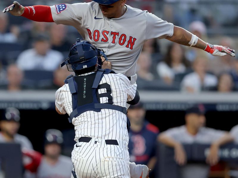 Jun 7, 2025; Bronx, New York, USA; New York Yankees catcher Austin Wells (28) tags out Boston Red Sox designated hitter Rafael Devers (11) trying to score on a fielders choice ground ball by catcher Carlos Narvaez (not pictured) during the third inning at Yankee Stadium. Mandatory Credit: Brad Penner-Imagn Images