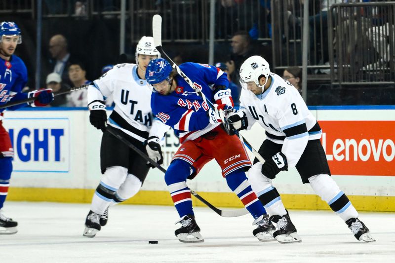 Oct 12, 2024; New York, New York, USA; New York Rangers left wing Artemi Panarin (10) tries to gain control of the puck against Utah Hockey Club center Nick Schmaltz (8) during the first period at Madison Square Garden. Mandatory Credit: John Jones-Imagn Images