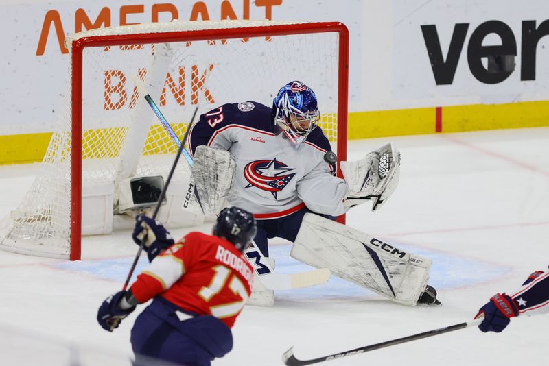 Apr 11, 2024; Sunrise, Florida, USA; Columbus Blue Jackets goaltender Jet Greaves (73) makes a save against Florida Panthers center Evan Rodrigues (17) during the first period at Amerant Bank Arena. Mandatory Credit: Sam Navarro-USA TODAY Sports