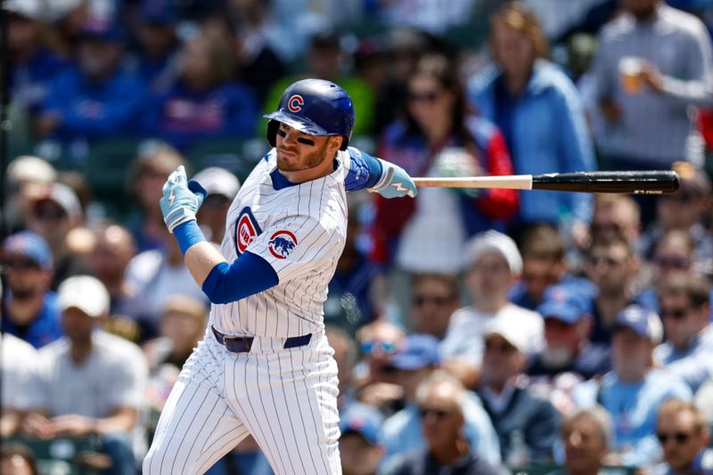 May 3, 2024; Chicago, Illinois, USA; Chicago Cubs outfielder Ian Happ (8) singles against the Milwaukee Brewers during the first inning at Wrigley Field. Mandatory Credit: Kamil Krzaczynski-USA TODAY Sports