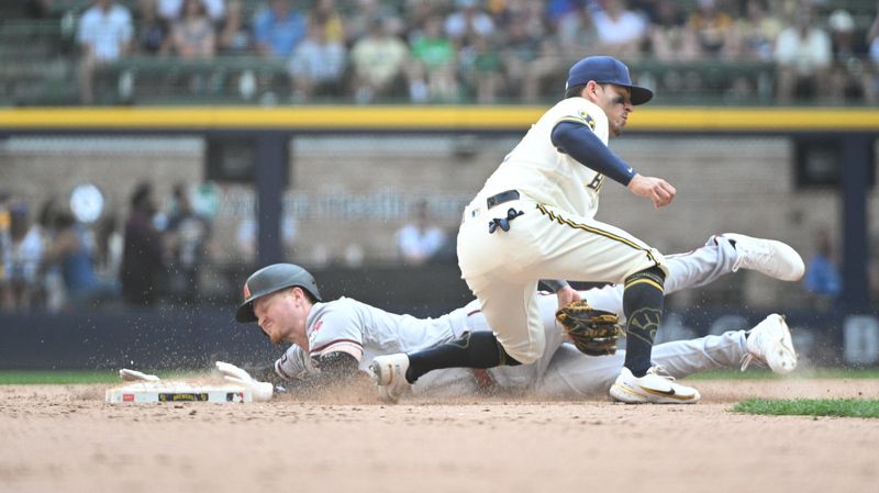 Jun 21, 2023; Milwaukee, Wisconsin, USA; Arizona Diamondbacks designated hitter Pavin Smith (26) slides in safely ahead of the tag by Milwaukee Brewers left fielder Raimel Tapia (3) in the eighth inning at American Family Field. Mandatory Credit: Michael McLoone-USA TODAY Sports