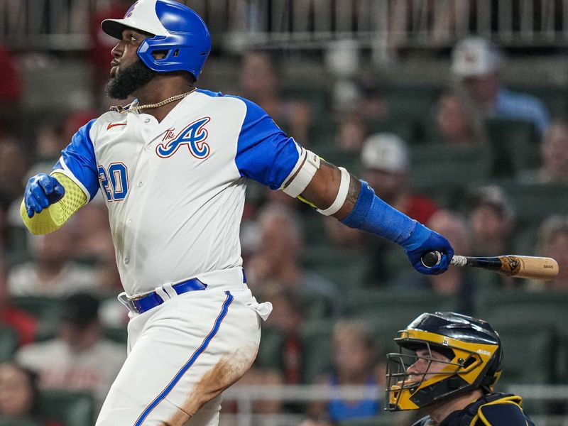 Jul 29, 2023; Cumberland, Georgia, USA; Atlanta Braves designated hitter Marcell Ozuna (20) follows through after hitting a two run home run against the Milwaukee Brewers during the seventh inning at Truist Park. Mandatory Credit: Dale Zanine-USA TODAY Sports