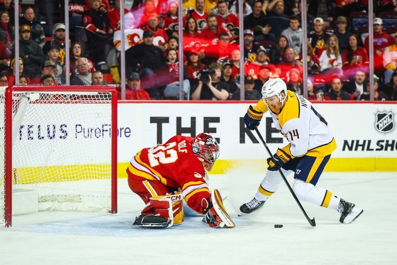 Nov 15, 2024; Calgary, Alberta, CAN; Calgary Flames goaltender Dustin Wolf (32) makes a save against Nashville Predators center Gustav Nyquist (14) during the first period at Scotiabank Saddledome. Mandatory Credit: Sergei Belski-Imagn Images