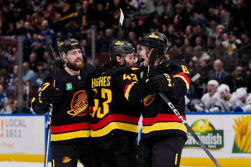 Dec 12, 2023; Vancouver, British Columbia, CAN; Vancouver Canucks defenseman Filip Hronek (17) and defenseman Quinn Hughes (43) and forward Brock Boeser (6) celebrate Boeser   s second goal of the game against the Tampa Bay Lightning in the second period at Rogers Arena. Mandatory Credit: Bob Frid-USA TODAY Sports