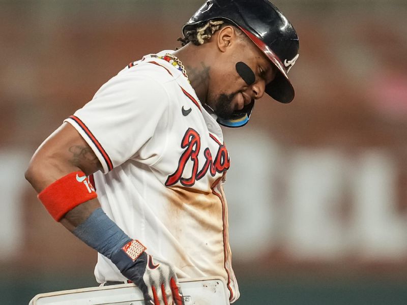 Sep 27, 2023; Cumberland, Georgia, USA; Atlanta Braves right fielder Ronald Acuna Jr. (13) reacts after stealing his 70th base of the season against the Chicago Cubs during the tenth inning at Truist Park. Mandatory Credit: Dale Zanine-USA TODAY Sports