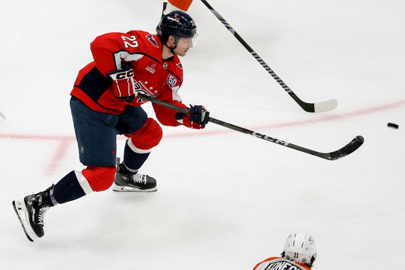 Mar 20, 2025; Washington, District of Columbia, USA; Washington Capitals right wing Brandon Duhaime (22) clears the puck during the second period against the Philadelphia Flyers at Capital One Arena. Mandatory Credit: Daniel Kucin Jr.-Imagn Images