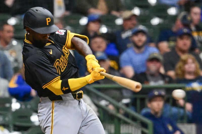 May 13, 2024; Milwaukee, Wisconsin, USA; Pittsburgh Pirates designated hitter Andrew McCutchen (22) hits a single to drive in a run in the seventh inning against the Milwaukee Brewers at American Family Field. Mandatory Credit: Benny Sieu-USA TODAY Sports