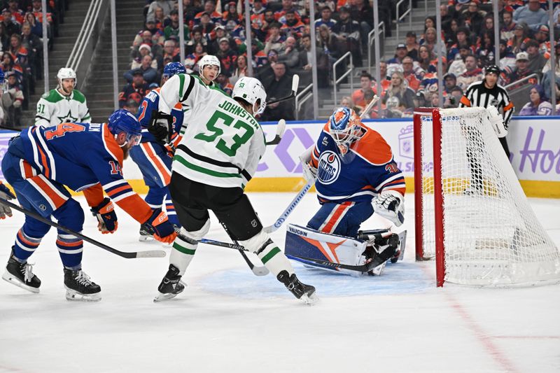 Nov 25, 2025; Edmonton, Alberta, CAN;  Edmonton Oilers defenceman Mattias Ekholm (14) goes after Dallas Stars centre Wyatt Johnson (53) in front of Edmonton Oilers goalie Calvin Pickard (30) during the second period at Rogers Place. Mandatory Credit: Walter Tychnowicz-Imagn Images