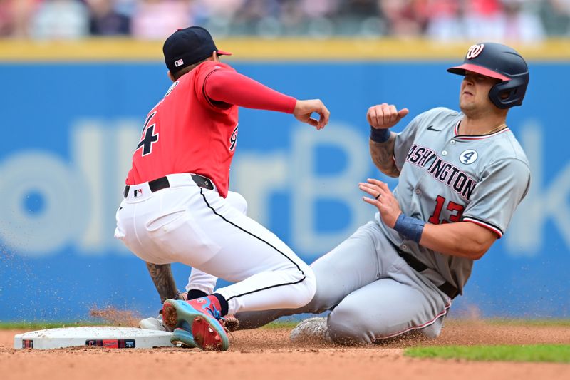 Jun 2, 2024; Cleveland, Ohio, USA; Cleveland Guardians shortstop Brayan Rocchio (4) tags out Washington Nationals third baseman Nick Senzel (13) stealing during the eighth inning at Progressive Field. Mandatory Credit: Ken Blaze-USA TODAY Sports