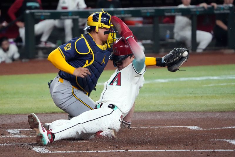 Sep 13, 2024; Phoenix, Arizona, USA; Arizona Diamondbacks outfielder Corbin Carroll (7) slides and beats a throw to Milwaukee Brewers catcher William Contreras (24) during the first inning at Chase Field. Mandatory Credit: Joe Camporeale-Imagn Images