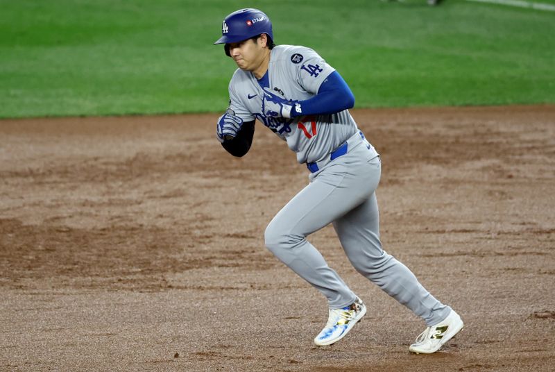 Oct 28, 2024; New York, New York, USA; Los Angeles Dodgers two-way player Shohei Ohtani (17) runs to second on a force out during the ninth inning against the New York Yankees in game three of the 2024 MLB World Series at Yankee Stadium. Mandatory Credit: Vincent Carchietta-Imagn Images