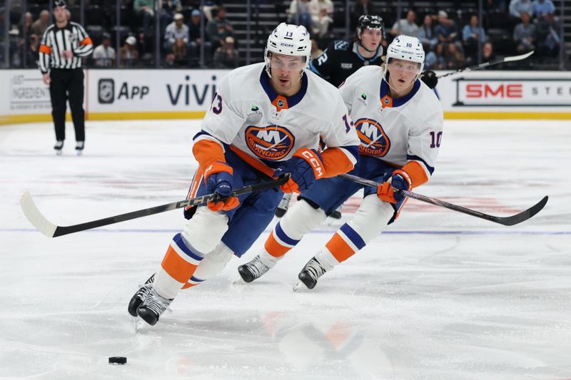 Nov 14, 2025; Salt Lake City, Utah, USA; New York Islanders center Mathew Barzal (13) and right wing Simon Holmstrom (10) bring the puck up the ice against the Utah Mammoth during the second period at Delta Center. Mandatory Credit: Rob Gray-Imagn Images