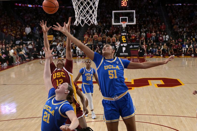 Jan 14, 2024; Los Angeles, California, USA; UCLA Bruins center Lauren Betts (51), forward Lina Sontag (21) and USC Trojans guard JuJu Watkins (12) go for a rebound in the first half at Galen Center. Mandatory Credit: Jayne Kamin-Oncea-USA TODAY Sports