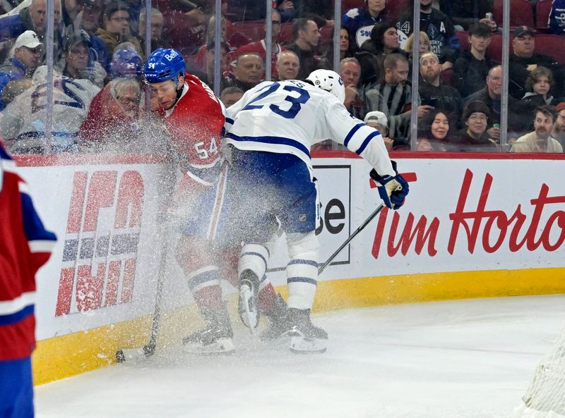 Apr 6, 2024; Montreal, Quebec, CAN; Toronto Maple Leafs forward Matthew Knies (23) checks Montreal Canadiens defenseman Jordan Harris (54) during the first period at the Bell Centre. Mandatory Credit: Eric Bolte-USA TODAY Sports