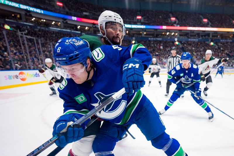 Jan 18, 2024; Vancouver, British Columbia, CAN; Arizona Coyotes defenseman Matt Dumba (24) battles with Vancouver Canucks forward Brock Boeser (6) in the third period at Rogers Arena. Vancouver won 2-1. Mandatory Credit: Bob Frid-USA TODAY Sports