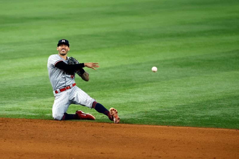 Sep 2, 2023; Arlington, Texas, USA; Minnesota Twins shortstop Carlos Correa (4) throws to first base in the seventh inning against the Texas Rangers at Globe Life Field. Mandatory Credit: Tim Heitman-USA TODAY Sports