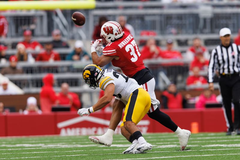 Oct 14, 2023; Madison, Wisconsin, USA;  Iowa Hawkeyes defensive back Sebastian Castro (29) breaks up the pass intended for Wisconsin Badgers tight end Riley Nowakowski (37) during the second quarter at Camp Randall Stadium. Mandatory Credit: Jeff Hanisch-USA TODAY Sports