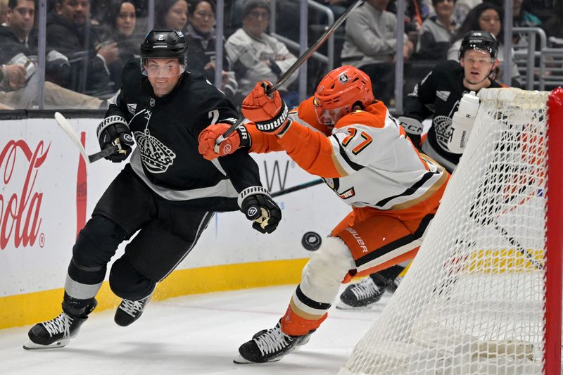 Dec 27, 2025; Los Angeles, California, USA; Los Angeles Kings defenseman Brian Dumoulin (2) and Anaheim Ducks left wing Alex Killorn (17) battle for the puck in the first period at Crypto.com Arena. Mandatory Credit: Jayne Kamin-Oncea-Imagn Images