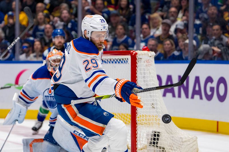 May 20, 2024; Vancouver, British Columbia, CAN; Edmonton Oilers forward Leon Draisaitl (29) reaches for the flying puck against the Vancouver Canucks during the first period in game seven of the second round of the 2024 Stanley Cup Playoffs at Rogers Arena. Mandatory Credit: Bob Frid-USA TODAY Sports