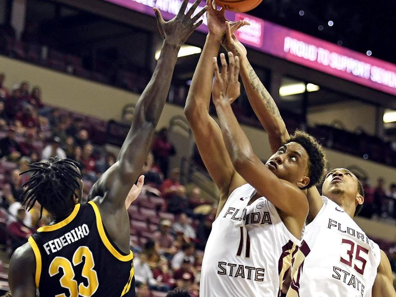 Feb 11, 2023; Tallahassee, Florida, USA; Pittsburgh Panthers center Federiko Federiko (33) fights for a rebound with Florida State Seminoles forward Baba Miller (11) during the first half at Donald L. Tucker Center. Mandatory Credit: Melina Myers-USA TODAY Sports