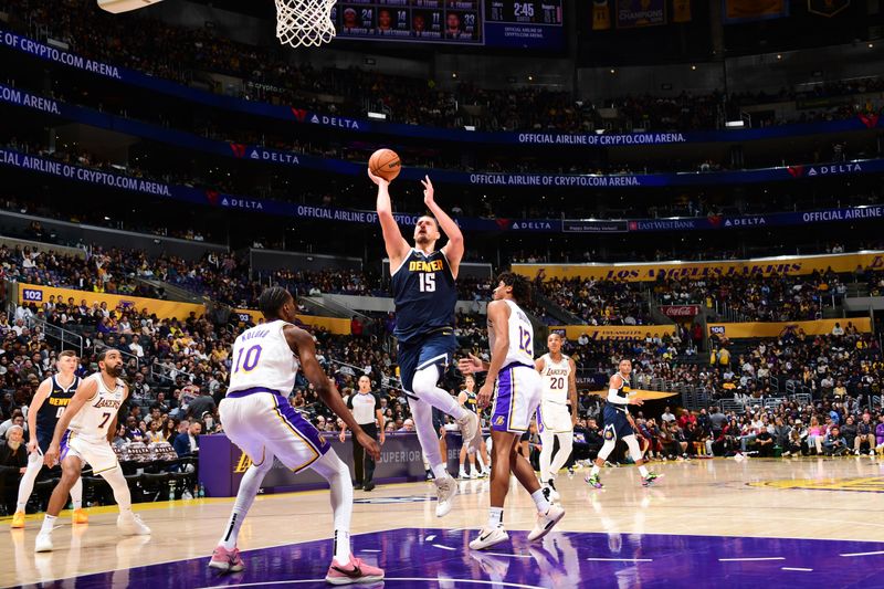 LOS ANGELES, CA - NOVEMBER 23: Nikola Jokic #15 of the Denver Nuggets drives to the basket during the game against the Los Angeles Lakers on November 23, 2024 at Crypto.Com Arena in Los Angeles, California. NOTE TO USER: User expressly acknowledges and agrees that, by downloading and/or using this Photograph, user is consenting to the terms and conditions of the Getty Images License Agreement. Mandatory Copyright Notice: Copyright 2024 NBAE (Photo by Adam Pantozzi/NBAE via Getty Images)