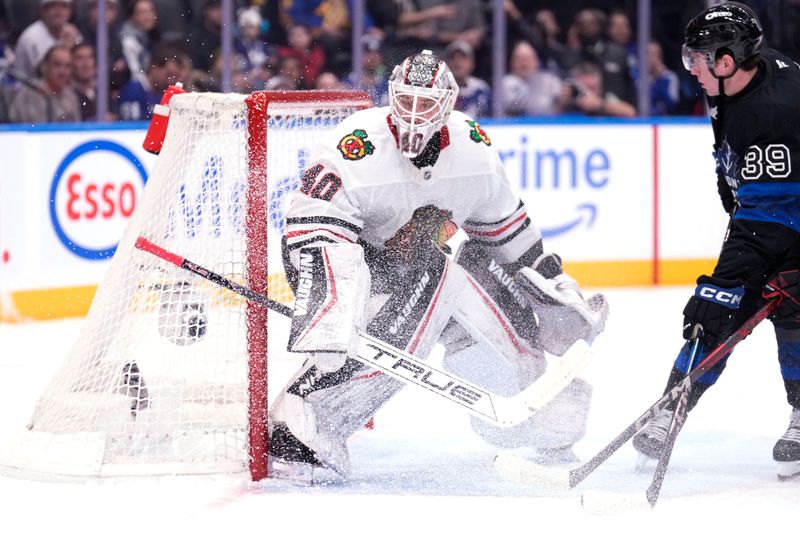 Dec 2, 2024; Toronto, Ontario, CAN; Chicago Blackhawks goaltender Arvid Soderblom (40) and Toronto Maple Leafs forward Fraser Minten (39) look for the puck during the first period at Scotiabank Arena. Mandatory Credit: John E. Sokolowski-Imagn Images