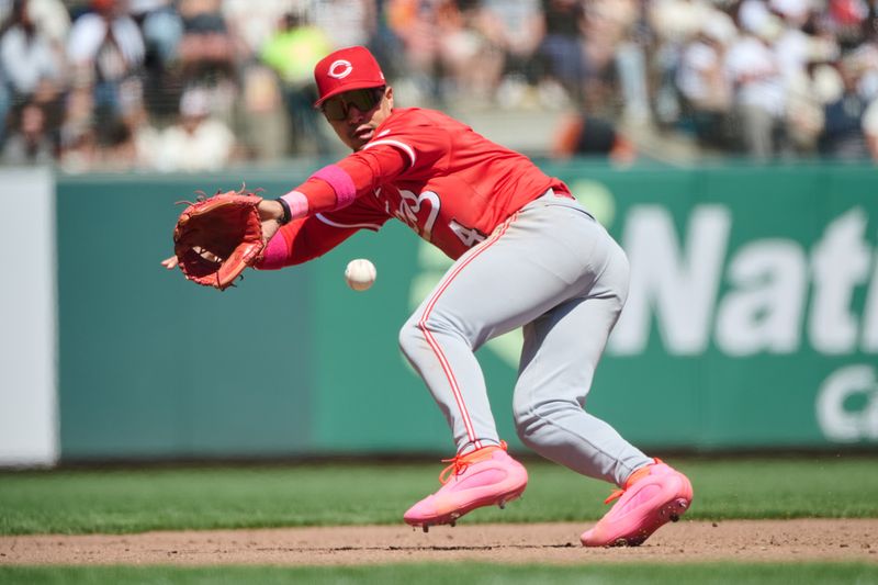 May 12, 2024; San Francisco, California, USA; Cincinnati Reds infielder Santiago Espinal (4) fields a ground ball against the San Francisco Giants during the sixth inning at Oracle Park. Mandatory Credit: Robert Edwards-USA TODAY Sports