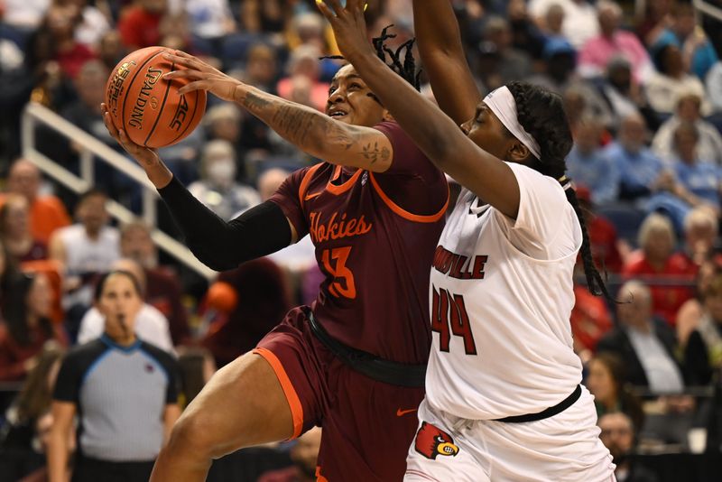 Mar 5, 2023; Greensboro, NC, USA; Virginia Tech Hokies forward Taylor Soule (13) drives past Louisville Cardinals forward Olivia Cochran (44) during the second half at Greensboro Coliseum. Mandatory Credit: William Howard-USA TODAY Sports