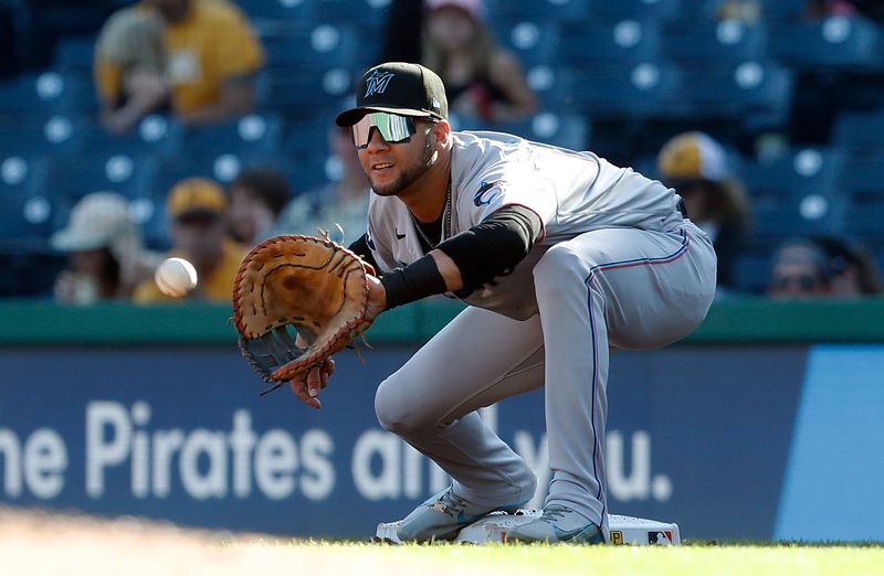 Oct 1, 2023; Pittsburgh, Pennsylvania, USA;  Miami Marlins first baseman Yuli Gurriel (10) takes a throw to retire Pittsburgh Pirates designated hitter Henry Davis (not pictured) during the fourth inning at PNC Park. Mandatory Credit: Charles LeClaire-USA TODAY Sports