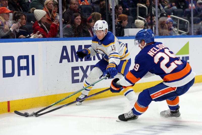 Nov 30, 2024; Elmont, New York, USA; Buffalo Sabres defenseman Henri Jokiharju (10) fights for the puck against New York Islanders center Brock Nelson (29) during the second period at UBS Arena. Mandatory Credit: Brad Penner-Imagn Images