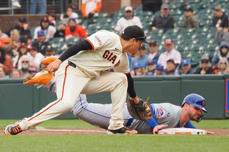 Apr 24, 2024; San Francisco, California, USA;  New York Mets first baseman Pete Alonso (20) safely dives back to first base below San Francisco Giants first baseman Wilmer Flores (41) during the fifth inning at Oracle Park. Mandatory Credit: Kelley L Cox-USA TODAY Sports