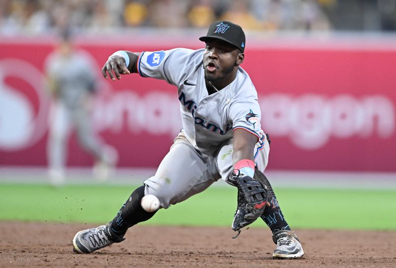 May 27, 2025; San Diego, California, USA; Miami Marlins second baseman Ronny Simon (41) can’t make the stop on a ball hit by San Diego Padres shortstop Xander Bogaerts (2) during the third inning at Petco Park. Simon was charged with an error on the play. Mandatory Credit: Denis Poroy-Imagn Images