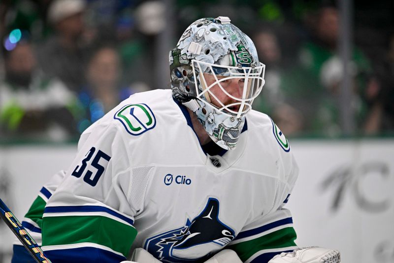 Jan 31, 2025; Dallas, Texas, USA; Vancouver Canucks goaltender Thatcher Demko (35) faces the Dallas Stars attack during the second period at the American Airlines Center. Mandatory Credit: Jerome Miron-Imagn Images