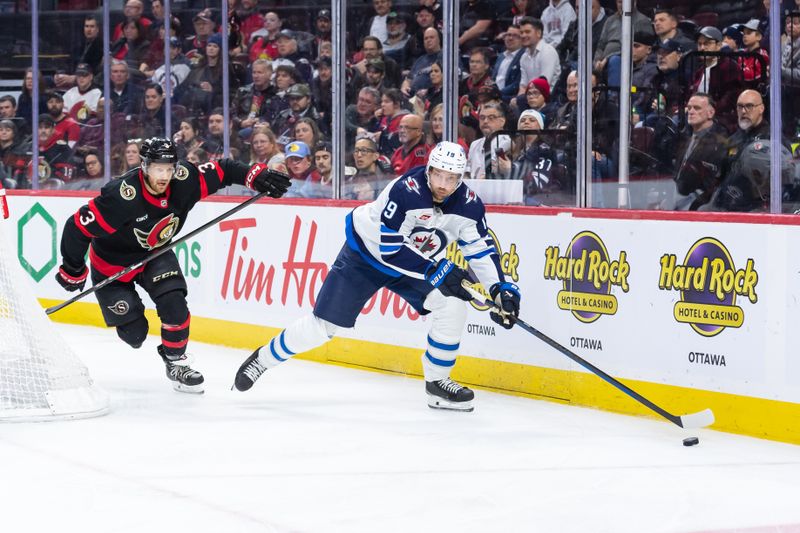 Feb 26, 2025; Ottawa, Ontario, CAN; Winnipeg Jets center David Gustafsson (19) skates with the puck in front of Ottawa Senators defenseman Nick Jensen (3) in the second period at the Canadian Tire Centre. Mandatory Credit: Marc DesRosiers-Imagn Images