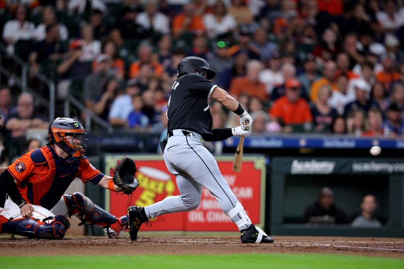 Aug 16, 2024; Houston, Texas, USA; Chicago White Sox right fielder Dominic Fletcher (7) hits into a fielder's choice to score a run against the Houston Astros during the second inning at Minute Maid Park. Mandatory Credit: Erik Williams-USA TODAY Sports