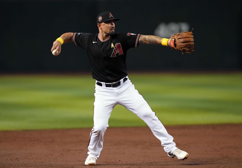 Sep 3, 2023; Phoenix, Arizona, USA; Arizona Diamondbacks third baseman Jace Peterson (6) throws to first base against the Baltimore Orioles during the third inning at Chase Field. Mandatory Credit: Joe Camporeale-USA TODAY Sports