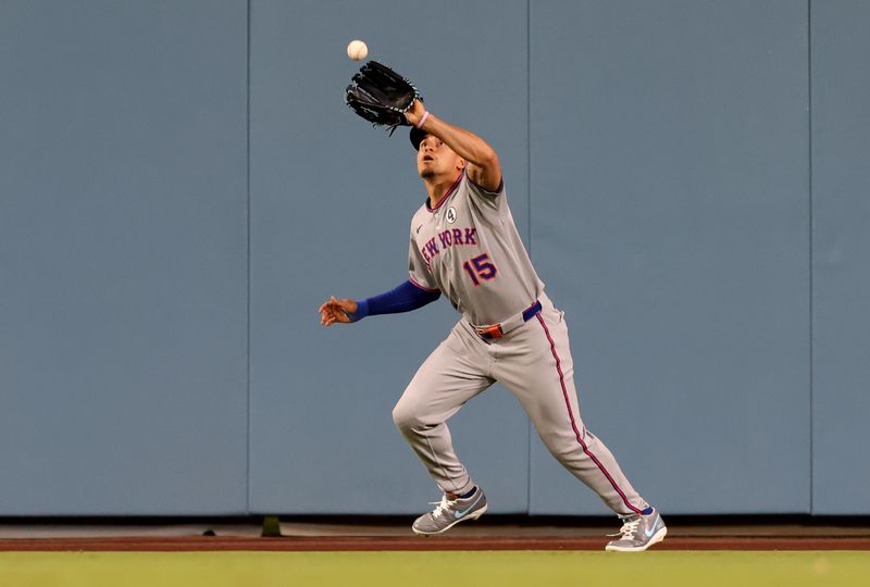 Jun 2, 2025; Los Angeles, California, USA; New York Mets outfielder Tyrone Taylor (15) makes a catch during the fifth inning against the Los Angeles Dodgers at Dodger Stadium. Mandatory Credit: Jason Parkhurst-Imagn Images